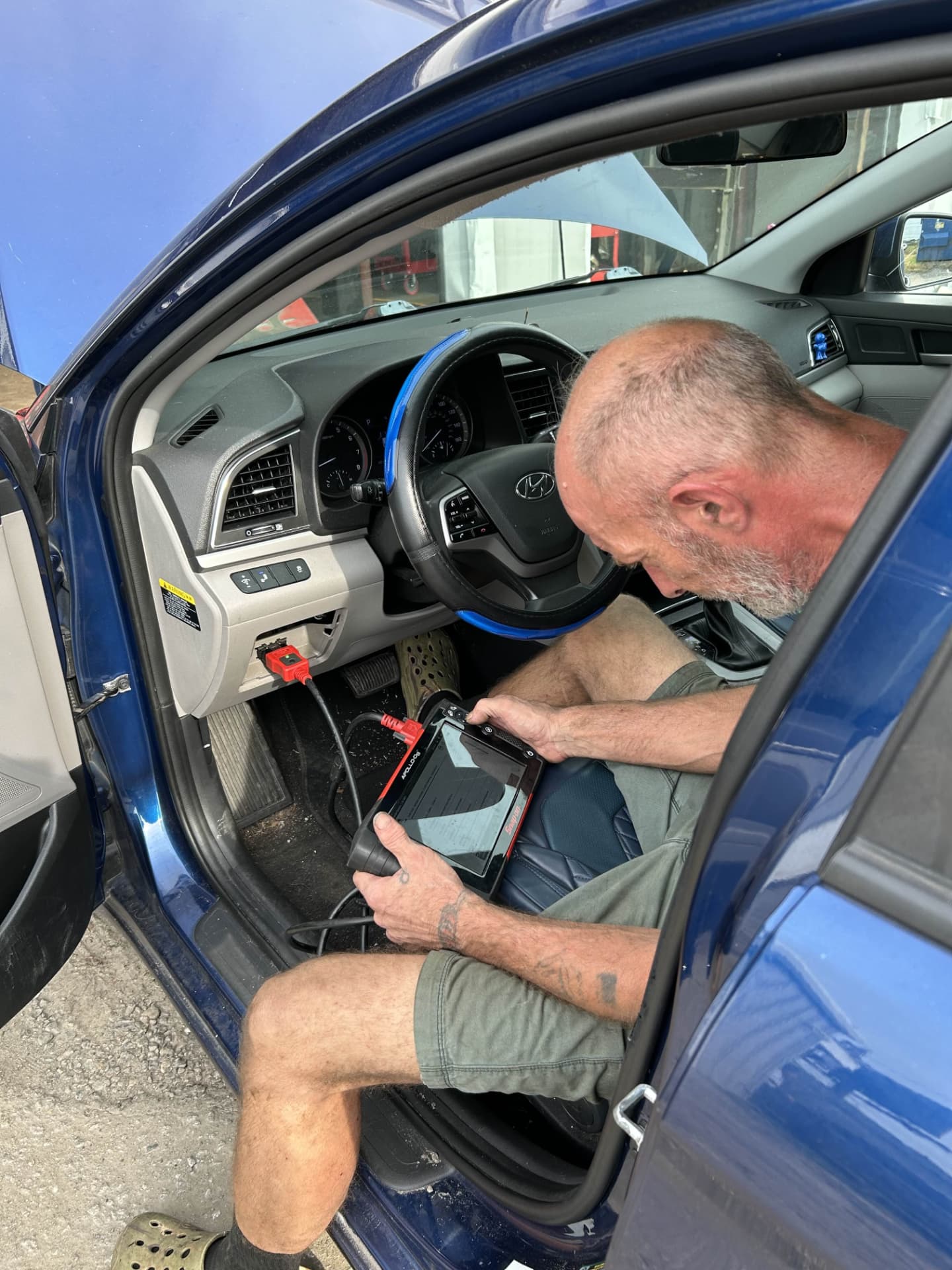 Champion Tires & Brakes technician running a Snap-on scan tool diagnostic on a Hyundai in North Charleston